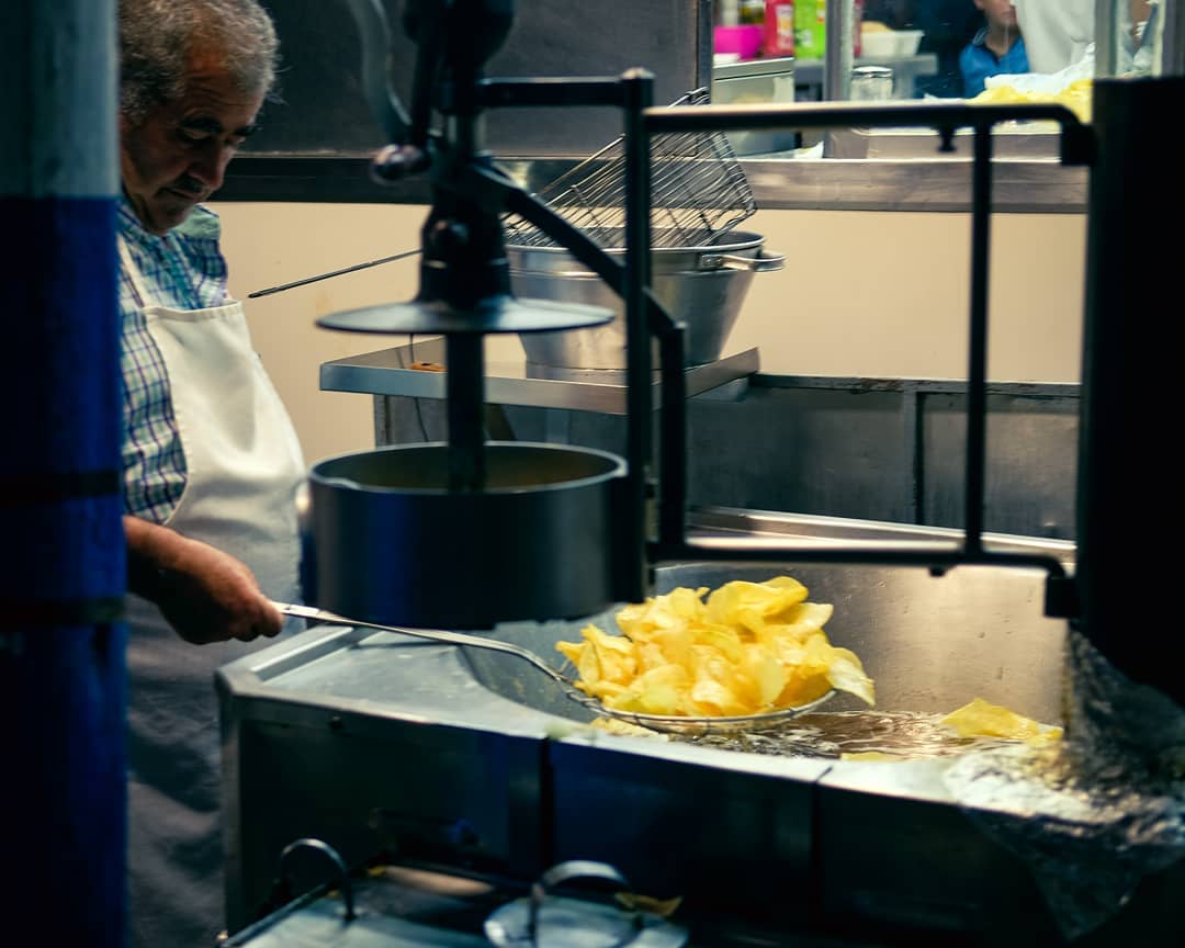 A picture of a Man frying fries